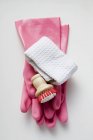 Closeup top view of pink rubber gloves, brush and towel — Stock Photo
