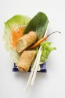 Spring roll on salad — Stock Photo