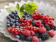 Fresh berries in glass bowl — Stock Photo