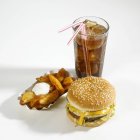 Cheeseburger, cunei di patate e cola — Foto stock