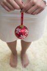 Woman holding a Christmas bauble — Stock Photo