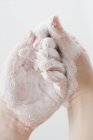 Closeup cropped view of hands covered with cream — Stock Photo
