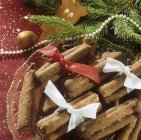 Closeup view of chocolate fingers with ribbons and fir branches — Stock Photo