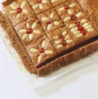Closeup view of cut tray-baked gingerbread with almonds — Stock Photo