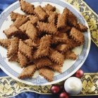 Closeup view of chocolate and almond cookies heap on plate — Stock Photo