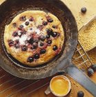 Blueberry pancake on frying pen — Stock Photo