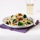 Spaghetti with broccoli and fried bacon — Stock Photo