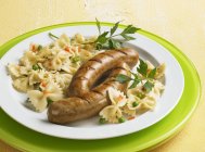Sausages with pasta salad — Stock Photo