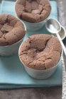 Closeup view of chocolate souffles with spoons — Stock Photo