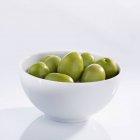 Green olives in bowl — Stock Photo