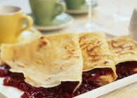 Closeup view of crepes with berry jam — Stock Photo
