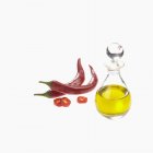 Chilli peppers and oil — Stock Photo