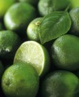 Limes whole and halved — Stock Photo