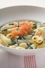 Penne with spinach and diced tomato — Stock Photo