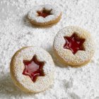 Linzer biscuits on icing sugar — Stock Photo