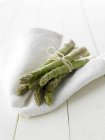 Green asparagus on white cloth — Stock Photo