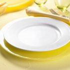 Closeup view of place setting in yellow and white colors — Stock Photo
