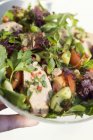 Thai turkey salad on plate in hand — Stock Photo
