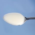 Spoonful of natural yoghurt — Stock Photo