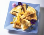 Crpes Suzette in blue plate on white surface — Stock Photo