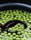 Peas in bowl of water — Stock Photo