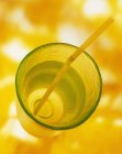 Closeup view of drink with straw on yellow background — Stock Photo