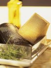 Parmesan with cheese grater — Stock Photo