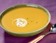 Pumpkin cream soup in rustic bowl — Stock Photo