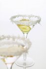 Closeup view of Sambuca anise liqueur with lemon and grated coconut — Stock Photo