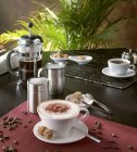 Cappuccino in Tasse mit Kaffeebohnen — Stockfoto