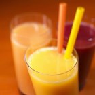 Orange juice with two straws — Stock Photo