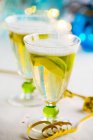 Glasses of sparkling wine with lemon wedges — Stock Photo
