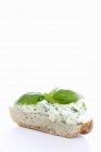 Courgette cream and basil on slice of white bread on white background — Stock Photo