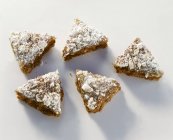 Gingerbread triangles sprinkled with meringue — Stock Photo