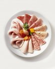 Cold cuts plate with mixed pickles — Stock Photo