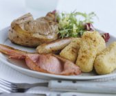 Sausage and steak with potato croquettes — Stock Photo
