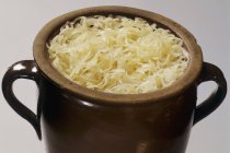 Sauerkraut in earthenware pot — Stock Photo