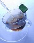 Glass cup with tea bag — Stock Photo