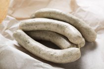 Closeup view of fresh Weisswurst sausages heap on paper — Stock Photo