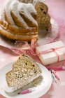 Closeup view of cut Gugelhupf with icing sugar and candles for birthday — Stock Photo
