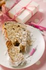 Closeup view of Gugelhupf piece with icing sugar and candles for birthday — Stock Photo
