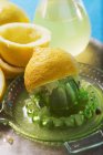 Squeezed lemons with lemon squeezer — Stock Photo
