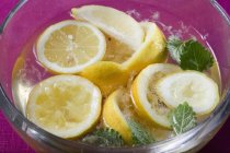 Squeezed lemons in water — Stock Photo