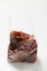 Dried tomatoes in cellophane bag — Stock Photo