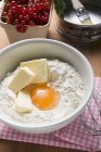 Flour with butter, egg in bowl — Stock Photo
