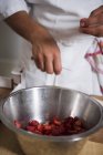 Chief chopping strawberries — Stock Photo