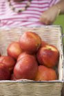 Nectarinas frescas en cesta - foto de stock
