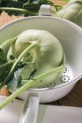 Washed Kohlrabi in colander — Stock Photo