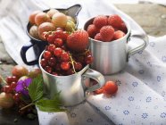 Summer berries in metal cups — Stock Photo