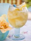 Closeup view of fruity pineapple drink with ice cubes and lemon — Stock Photo